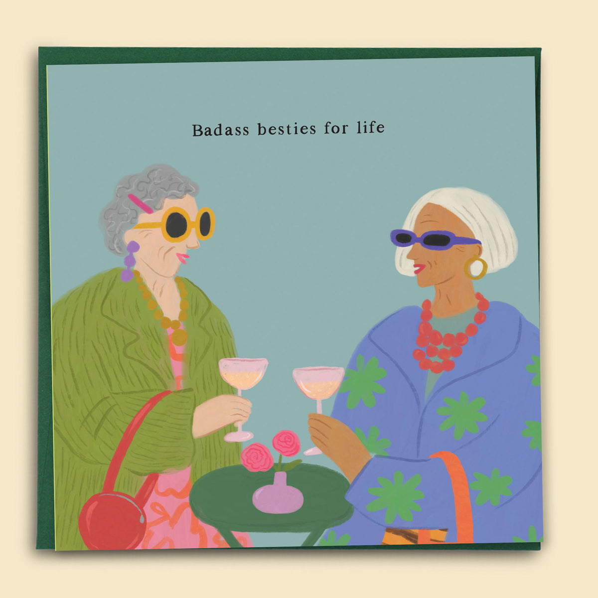 Illustrated by Constanza Goeppinger a greeting card featuring two older women drinkning a cocktail with the text 'Badass Besties For Life'. Australian-made greeting card by Papernest.